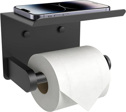 Matte black toilet paper holder with a top shelf holding a phone, with a roll on the bar
