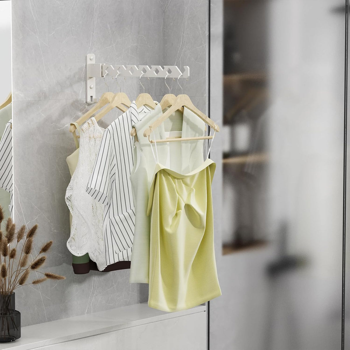 Drying rack folded out from a wall holding several tops