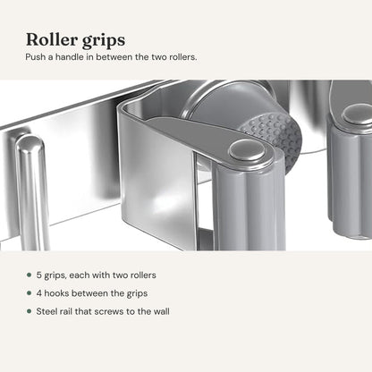 Broom holder close-up: a grip with two gray rollers on a steel rail, next to a hook.