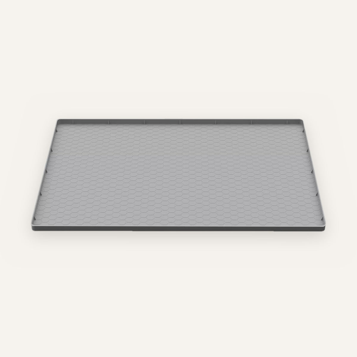 Under-sink leak mat: gray silicone tray with a raised edge and hexagon texture, shown alone.